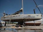 A worker cleans Champagne, a vessel that sank after an attack by orcas in the Strait of Gibraltar and was taken for repairs at the Pecci Shipyards in Barbate, near Cadiz, southern Spain, on May 31.