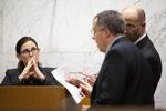 Defense attorney Dean Smith and prosecutor Jeff Howes discuss records shown to Portland police detective Michele Michaels during her testimony at the Multnomah County Courthouse on Feb. 13, 2020, day 11 in the trial of Jeremy Christian for the stabbing of three people on a MAX train in Portland in May 2017.