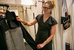 Erica Lurie shows off a sample of a jacket she designed at the Garnish boutique in Old Town Portland, Ore., July 27, 2023. Lurie founded Garnish, a womenswear boutique filled with her designs, in 2004. 