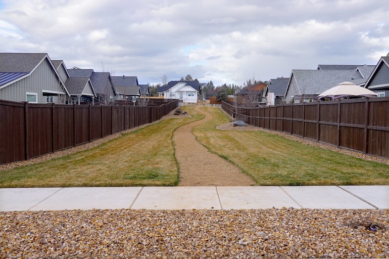 A strip of communal green space conjoins lots in a Redmond subdivision, Prairie Crossing, which some city officials hope will become a model for saving water across the city.
