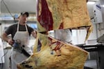 Workers at BillyBob's Butchers in Elgin, Oregon, cut a side of beef into portions on Thursday, Jan 19, 2023.