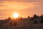 The sun sets in Fossil, Ore., as wildfire smoke blankets the area on July 21, 2026. The Rowe Creek Complex Fire, which spread to 149,000 acres by Tuesday, is a cluster of wildfires that were sparked by lightning storms last week.