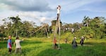 In this 2023 supplied photo, community members are building a solar PV system to bring sustainable electricity to their village in Dagat, Kinabatangan, Sabah, Malaysia. Green Empowerment, a Portland-based nonprofit, helped with the solar project.