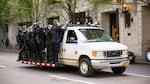 Police dressed in riot gear mobilize to follow a group of counter-protesters marching north on Portland's Southwest 4th Avenue. Police eventually pinned the marching crowd in, where they detained dozens of people, including several journalists.