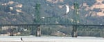 In this Aug. 2, 2010, file photo, a kite boarder sails along the Columbia River in Hood River, Ore. The Hood River-White Salmon Bridge is in the background.