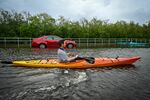 Residents use kayaks to travel on a flooded road in Tampa, Florida, Hurricane Idalia made landfall.