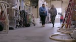 Two women walking in a winery.