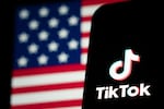 In this photo illustration, the TikTok logo and flag of the United States are seen on screens in January 2025 in Hong Kong, China.