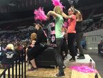 Fans of Arch Rival All-Stars and London Rollergirls cheer on their teams during a bout at the 2016 International WFTDA Championships in Portland's Veterans Memorial Coliseum.