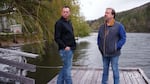 Copco Lake residents Francis Gil, left, and Danny Fontaine stand on a dock in May that they have to remove so that Copco Lake can be drained for dam removal.