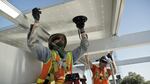 Workers install solar panels on the roof of the Bullitt Center in Seattle.