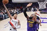 Portland Trail Blazers guard Anfernee Simons, left, shoots as Los Angeles Lakers forward LeBron James defends during the first half of an NBA basketball game, Thursday, Jan. 2, 2025, in Los Angeles.