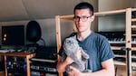 The musician, DJ and producer Andre Allen Anjos, who records under the moniker RAC, in his home studio, with cat.