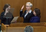 Gov. Tina Kotek takes her oath of office, with her wife, Aimee Kotek Wilson, by her side at the Oregon Capitol in Salem, Ore., Jan. 9, 2023.