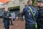 Law enforcement including Portland police Sgt. Jerry Cioeta, left, and other emergency responders at the scene where a man was revived following a fentanyl overdose, in downtown Portland, Ore., Dec. 13, 2023. This was the third time in one week that Cioeta revived an overdose victim.