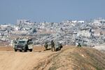 Israeli soldiers overlooking Gaza City on Monday.