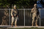 Members of the Texas National Guard stand guard at an army reserve training facility on October 07, 2025 in Elwood, Illinois.