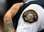 A liaison officer with the Portland Police Bureau watches people at a rally organized by the Proud Boys, labeled a hate group by the Southern Poverty Law Center, in Portland, Ore., Saturday, Aug. 17, 2019.