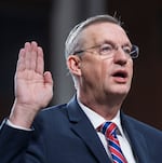 FILE - Doug Collins, then-Secretary-elect of the Department of Veterans' Affairs, being sworn-in to testify at his confirmation hearing before the Senate Veterans' Affairs Committee, at the Capitol in Washington, Jan. 21, 2025. Collins has insisted that veterans’ health care and benefits are not on the chopping block.