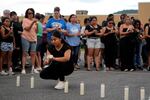 Tennessee Immigrant and Refugee Rights Coalition worker Ana Gutierrez lights a candle during a vigil for victims of the Impact Plastics tragedy in the days after Hurricane Helene in Erwin, Tenn. on Oct. 3.