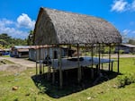Before the 2004 tsunami destroyed their villages, the indigenous Nicobarese lived in thatched roof shelters like these near the coast of the Great Nicobar island.
