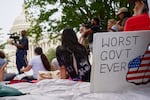 A sign saying "worst government ever" is seen by the Capitol during a rally with fired federal workers about the looming government shut down, Tuesday, Sept. 30, 2025, on Capitol Hill in Washington.