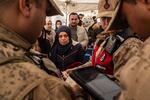 Turkish gendarmerie check the documents of Syrian families living in Turkey at the Cilvegozu border gate as they wait to cross into Syria, on Dec. 13, after Syrian rebels ousted President Bashar al-Assad.