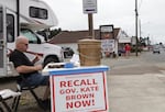 Michael Cross, leader of the "Flush Down Kate Brown" campaign, collects signatures for a recall petition on Aug. 7, 2019.