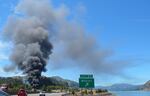 A plume of smoke rises from where a train carrying crude oil derailed in Mosier, near Hood River, on Friday afternoon.