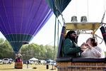 Bride and groom Kylee and Michael Rice prepare to take a hot air balloon ride before a planned mass wedding of over 200 couples at the Total Eclipse of the Heart festival Monday in Russellville, Ark.