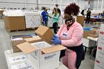 An employee with the McKesson Corporation packs a box of the Johnson and Johnson COVID-19 vaccine into a cooler for shipping from their facility in Shepherdsville, Ky., Monday, March 1, 2021.