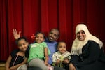 Munira, left, and her family pose for a photo during an OPB Class of 2025 event in 2014.
