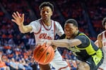 Oregon's Kwame Evans Jr. and Illinois' AJ Redd reach for a loose ball during the second half of an NCAA college basketball game Tuesday, March 3, 2026, in Champaign, Ill.