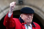 Former far-right National Front party leader Jean-Marie Le Pen clenches his fist at the statue of Joan of Arc in Paris in 2017