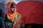 A girl poses for a portrait in a camp for internally displaced people on the outskirts of Baidoa, Somalia, on Dec. 14. As people flee their homes because of drought, famine and fighting, camps have sprung up this year around the Somali capital and other cities.