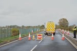 Police guard a road leading to RAF Fairford, a US Airbase, after an incident in Fairford, England , Sunday, Sept. 27, 2026.