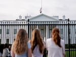 Visitors look upon the White House as the US flag flies at half mast following a school shooting in Nashville, Tennessee last March.