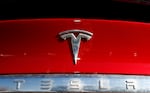 FILE - The Tesla company logo sits on an unsold 2020 Model X at a Tesla dealership in Littleton, Colo., on Feb. 2, 2020. The U.S. government's auto safety agency is investigating whether a recall in 2023 of Tesla's Autopilot driving system did enough to make sure drivers pay attention to the road. The National Highway Traffic Safety Administration says in documents posted on its website Friday, April 26, 2024, that it has concerns about the December recall of more than 2 million vehicles.