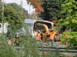 In this Oct. 4, 2023 photo, contractors with Sperry Tree Care feed trees and bushes into a wood chipper outside a Bethel residence. Crews began taking down roughly 17 trees from homes that texted high for dioxins in their soil. All were near the J.H. Baxter wood treatment facility.