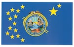 Oregon City's current flag features a seal at the center, being criticized by Mayor Denyse McGriff as having "too many things on it."