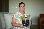Sue Phillips holds a photograph of her son, Matthew. He died after two members of a white supremacist gang beat him until he was unconscious in a recreation cage at Thomson.