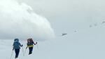 Skiing high into the clouds as a storm rolls in.