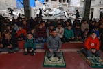 Palestinians perform Friday noon prayers at the Al-Hoda mosque, destroyed in Israeli bombardment in mid-February, after worshipers cleared rubble to make space for praying, in Rafah, the Gaza Strip, Feb. 23.