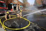 Portland firefighters douse the site of a gas explosion in Northeast Portland, Oct. 19, 2016.