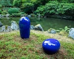 A ceramic statue by Jun Kaneko is nestled into a corner of the garden as part of the exhibition, "Garden of Resonance."