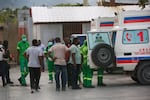 Medics inspect an ambulance of wounded people.