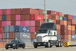 Shipping containers are seen at Port of Newark in Newark. N.J., on Oct. 4, 2024. Trump's plans to impose across-the-board tariffs could raise prices of a lot of goods while risking retaliation from trading partners.