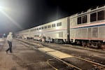 An amtrak train with people gathered in the front