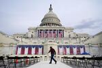 A worker pulls cables as preparations take place for President-elect Joe Biden's inauguration ceremony at the U.S. Capitol in Washington, Saturday, Jan. 16, 2021. (AP Photo/Patrick Semansky)