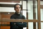 Wall Street Journal reporter Evan Gershkovich stands in a glass cage in a courtroom at the Moscow City Court on Thursday. The court upheld an earlier ruling to hold Gershkovich in pre-trial detention until at least Jan. 30, 2024.